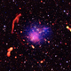 A composite image of Abell 2744 shows a galactic smattering of white, red, and purple.